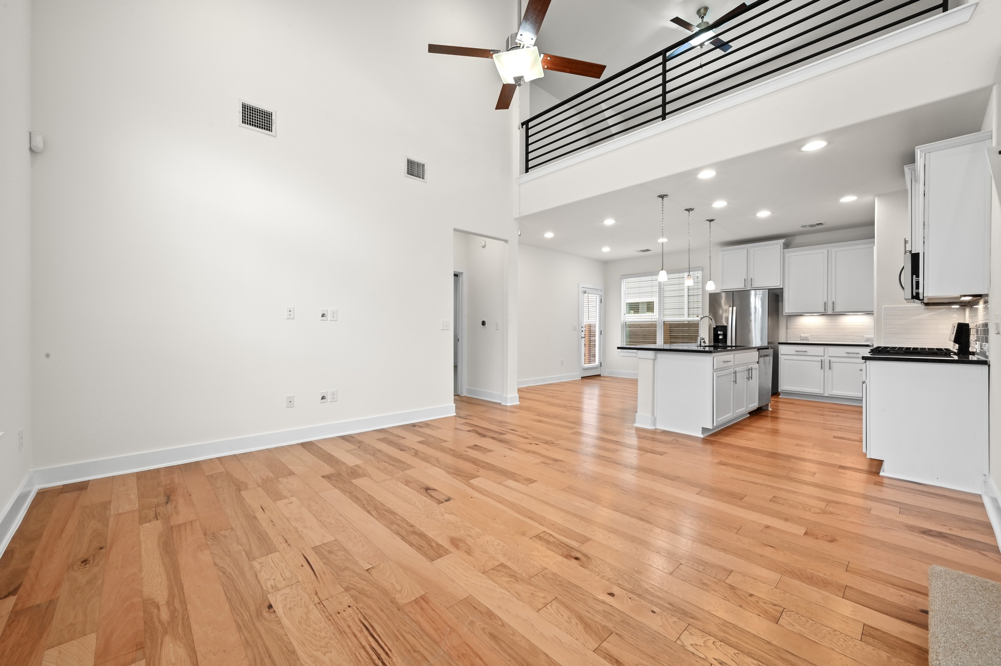 2204 Theseus Pass Austin, TX 78741 - Photo 6 of 31 a view of kitchen with kitchen island sink and refrigerator