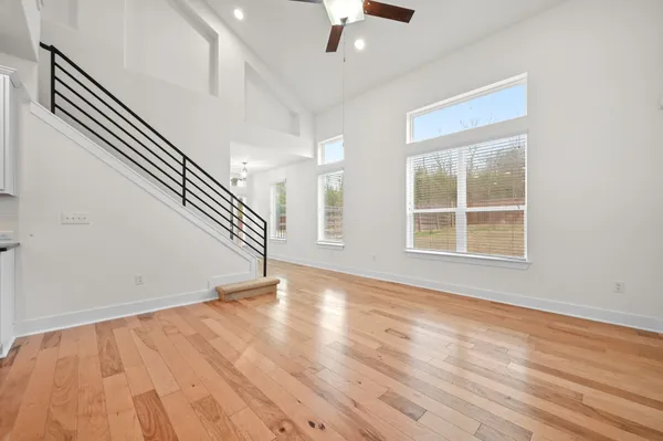 a large kitchen with stainless steel appliances kitchen island granite countertop a stove a sink and a refrigerator