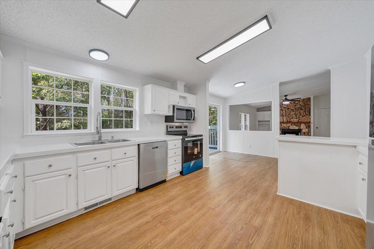 822 Buck Run Drive Critz, VA 24082 - Photo 12 of 55 a large kitchen with stainless steel appliances granite countertop a stove and a wooden floors