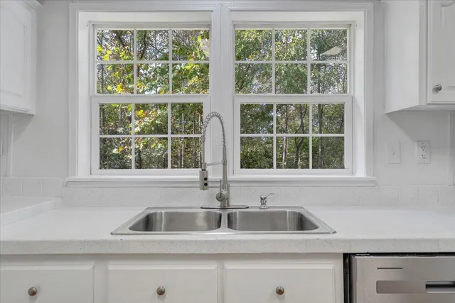a kitchen sink sitting next to a window
