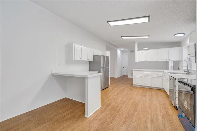 a view of kitchen with sink and wooden floor