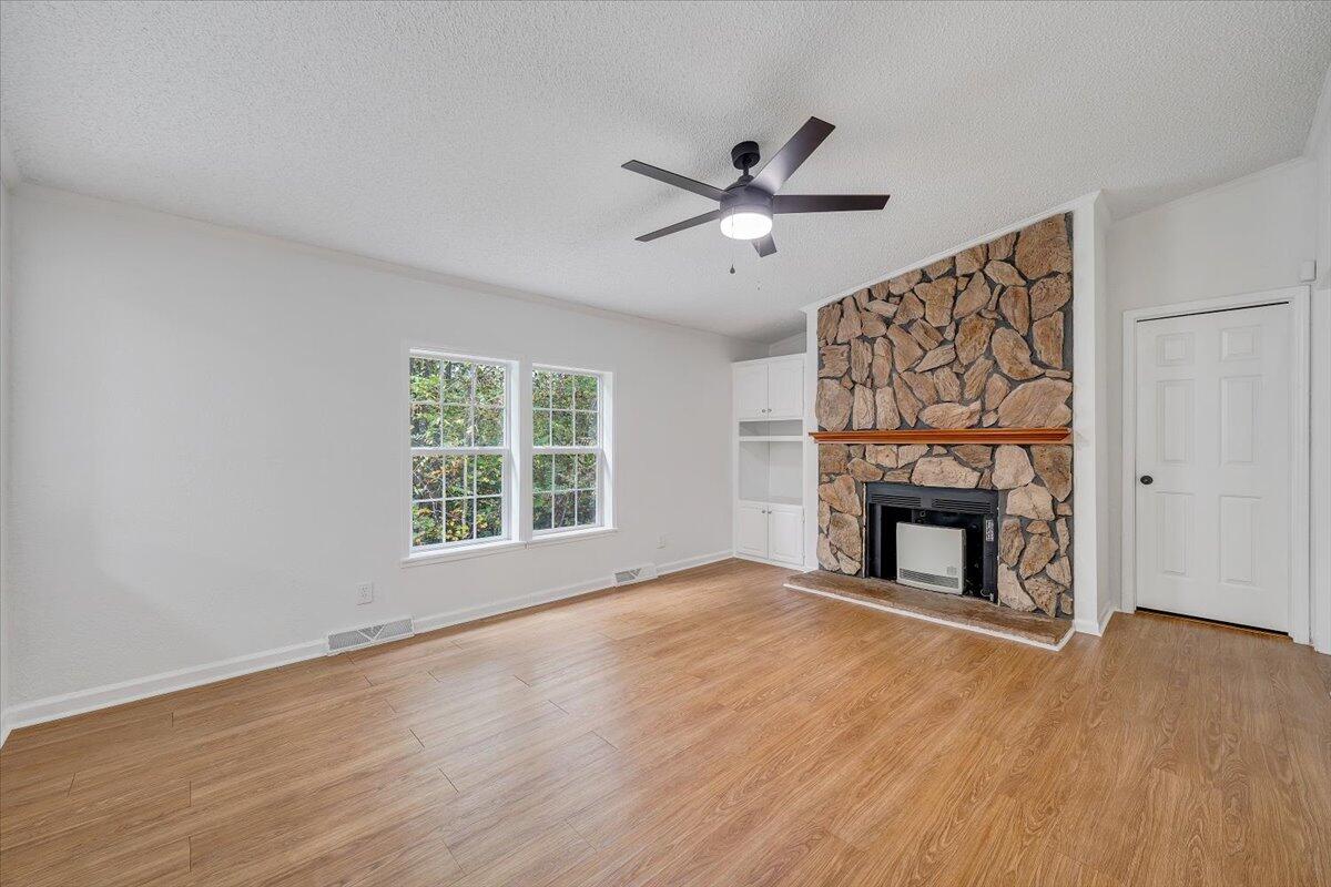 822 Buck Run Drive Critz, VA 24082 - Photo 20 of 55 a view of an empty room with a fireplace and a window