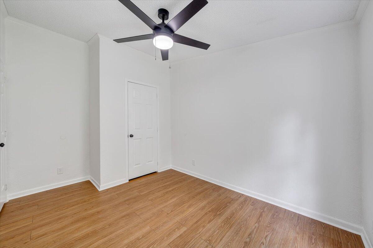 822 Buck Run Drive Critz, VA 24082 - Photo 27 of 55 an empty room with wooden floor and a ceiling fan