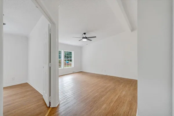 wooden floor in an empty room with a window