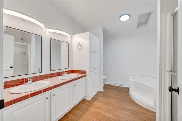 a bathroom with double vanity sinks and a mirror