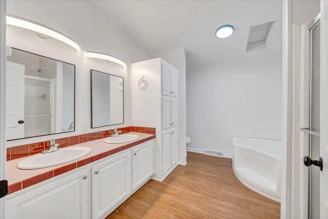 a bathroom with double vanity sinks and a mirror