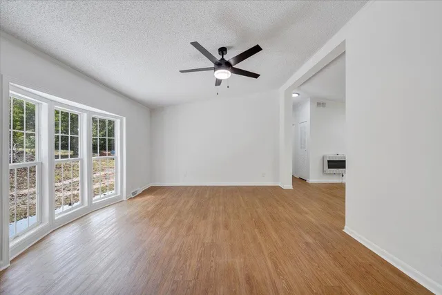 wooden floor in an empty room with a window