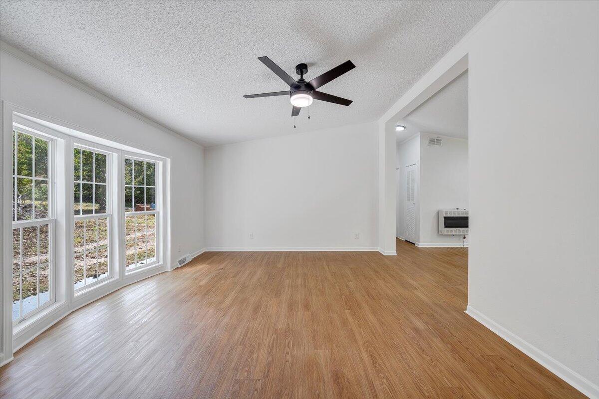 822 Buck Run Drive Critz, VA 24082 - Photo 4 of 55 wooden floor in an empty room with a window
