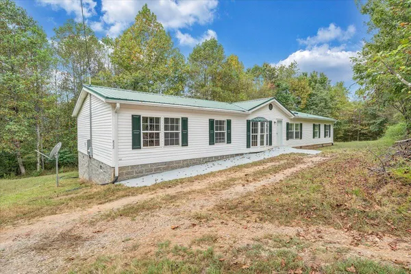 a house that has a tree in front of it