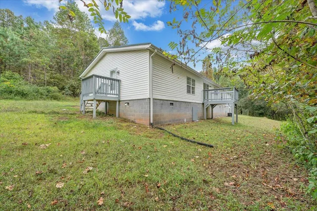 a view of a house with a backyard
