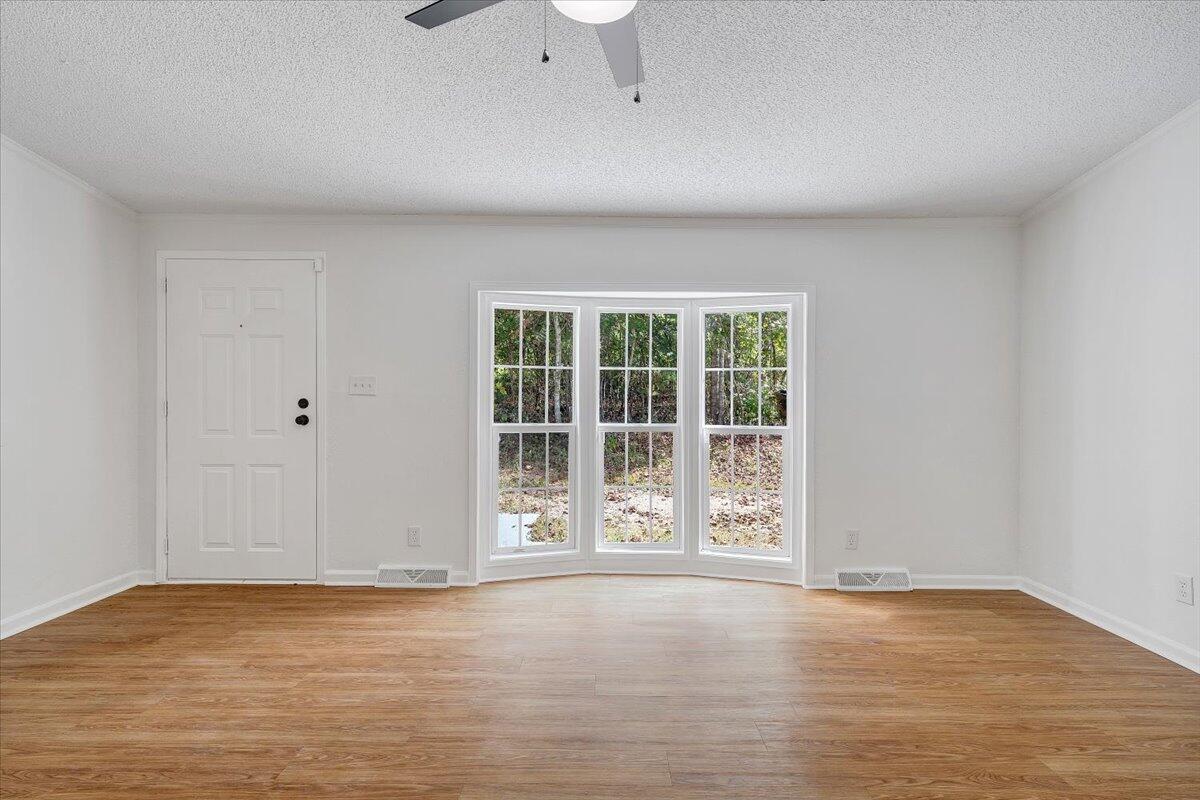822 Buck Run Drive Critz, VA 24082 - Photo 5 of 55 a view of an empty room with wooden floor and a window
