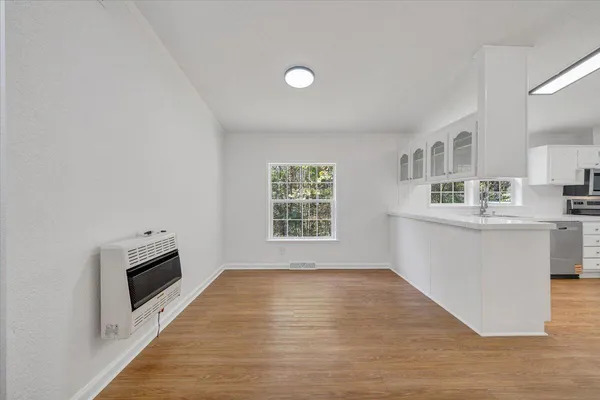 a kitchen with granite countertop a stove a sink and a microwave