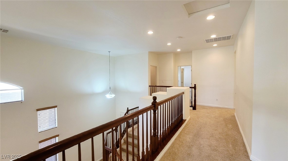 5913 Altissimo Street North Las Vegas, NV 89081 - Photo 21 of 37 Hall with recessed lighting, light colored carpet, and an upstairs landing