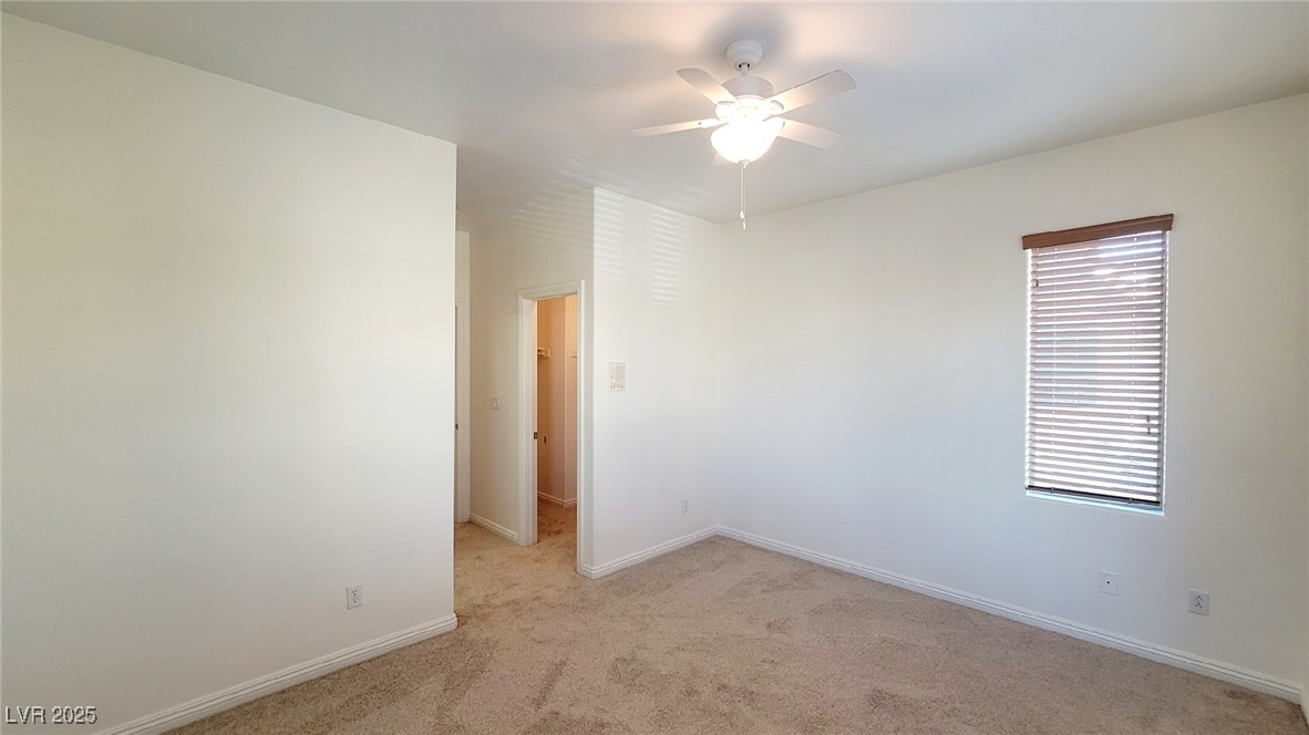 5913 Altissimo Street North Las Vegas, NV 89081 - Photo 28 of 37 Spare room featuring light carpet and a ceiling fan