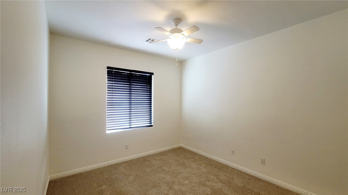 5913 Altissimo Street North Las Vegas, NV 89081 - Photo 30 of 37 Spare room featuring light carpet and a ceiling fan