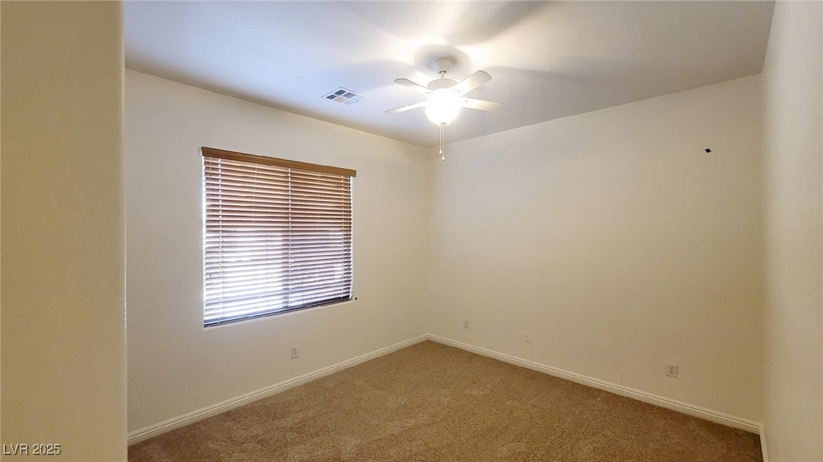 5913 Altissimo Street North Las Vegas, NV 89081 - Photo 33 of 37 Carpeted spare room with baseboards and ceiling fan