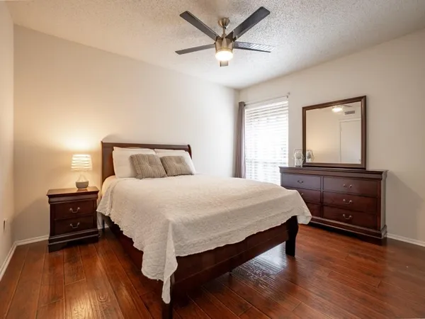 a bedroom with a bed and a ceiling fan