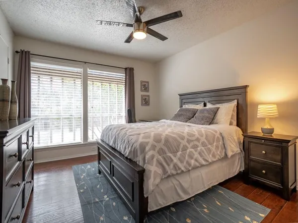 a spacious bedroom with a bed and a chandelier