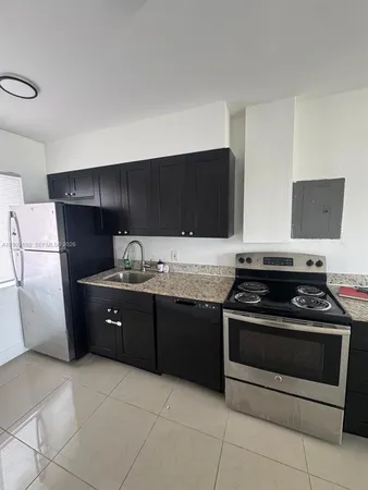 a kitchen with granite countertop a stove and a sink