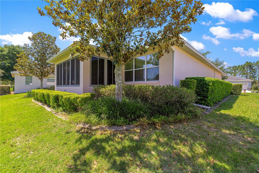 9317 Southwest 94th Loop Ocala, FL 34481 - Photo 35 of 40 a view of a house with a tree in a yard