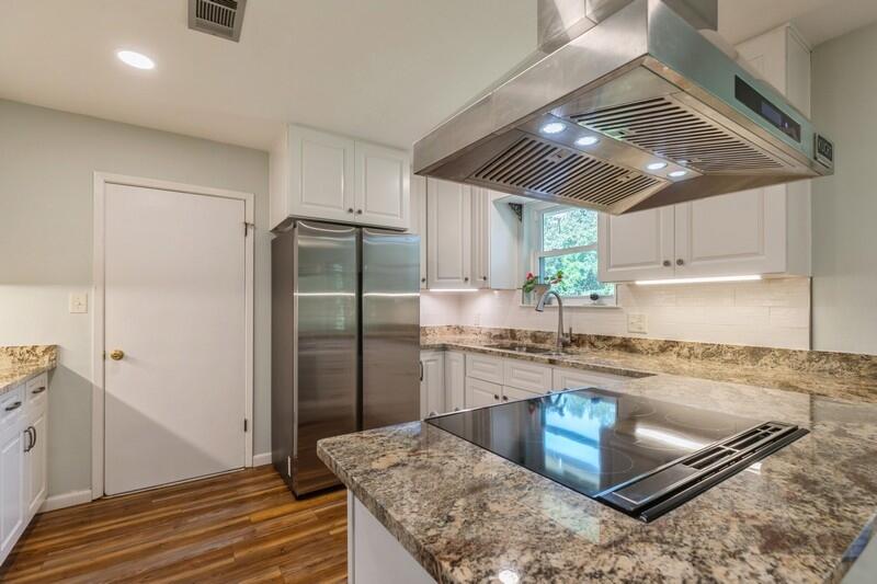 1086 County Highway 183 North DeFuniak Springs, FL 32433 - Photo 11 of 39 a kitchen with stainless steel appliances granite countertop a sink window and refrigerator