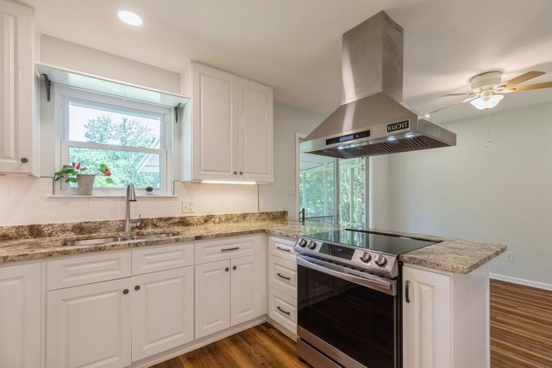 1086 County Highway 183 North DeFuniak Springs, FL 32433 - Photo 12 of 39 a kitchen with stainless steel appliances granite countertop a sink a stove and a window