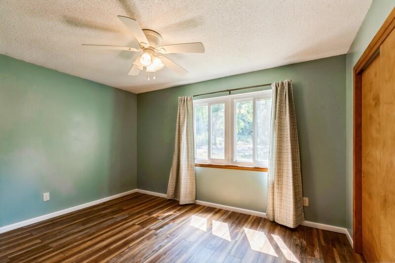 1086 County Highway 183 North DeFuniak Springs, FL 32433 - Photo 15 of 39 an empty room with wooden floor fan and windows