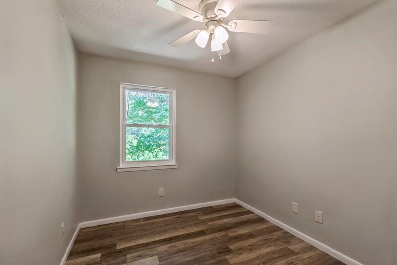 1086 County Highway 183 North DeFuniak Springs, FL 32433 - Photo 19 of 39 an empty room with a window and a fan