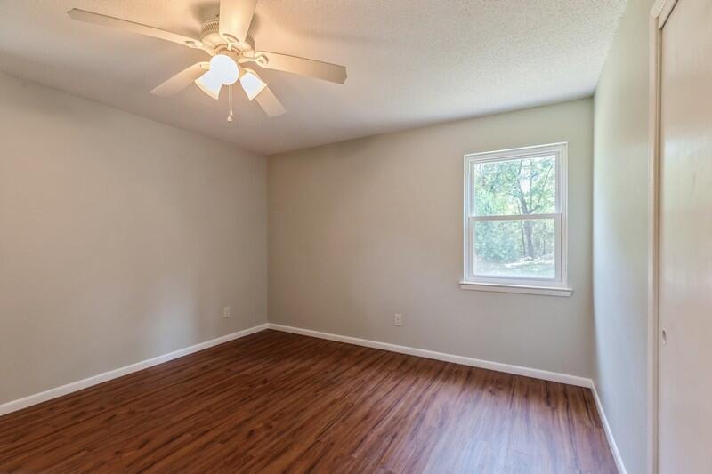 1086 County Highway 183 North DeFuniak Springs, FL 32433 - Photo 22 of 39 wooden floor in an empty room with a window