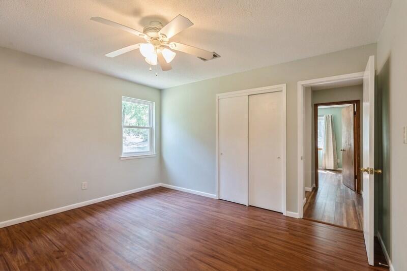 1086 County Highway 183 North DeFuniak Springs, FL 32433 - Photo 23 of 39 wooden floor in an empty room with a window