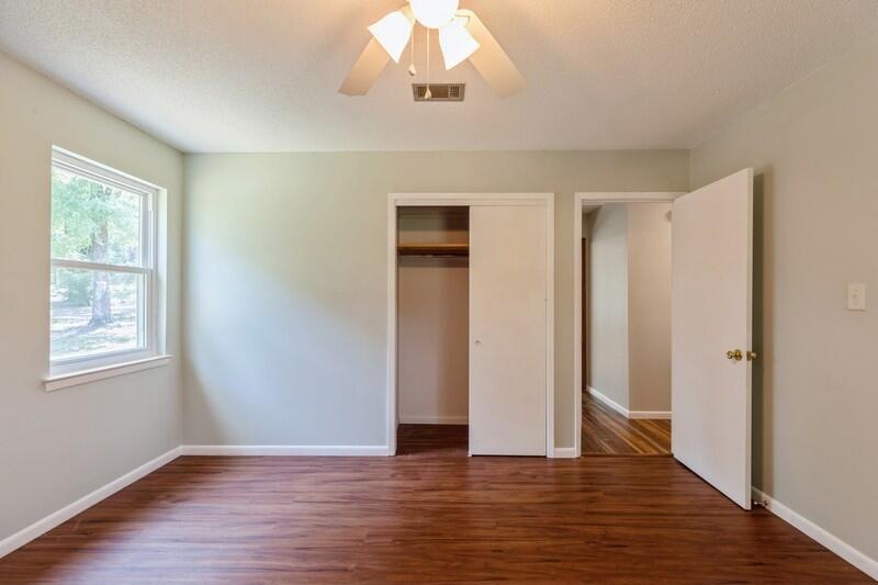 1086 County Highway 183 North DeFuniak Springs, FL 32433 - Photo 25 of 39 an empty room with wooden floor and windows