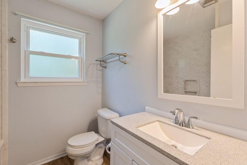1086 County Highway 183 North DeFuniak Springs, FL 32433 - Photo 26 of 39 a bathroom with a granite countertop sink toilet and mirror