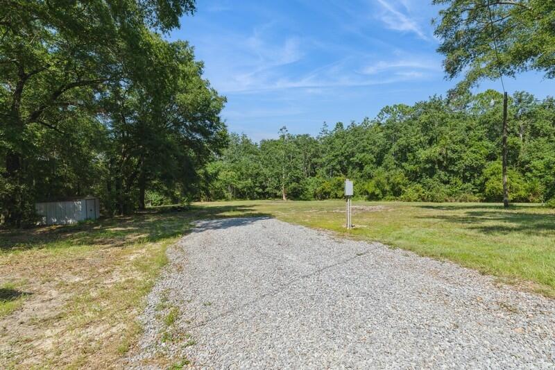 1086 County Highway 183 North DeFuniak Springs, FL 32433 - Photo 32 of 39 a view of a swimming pool with a yard