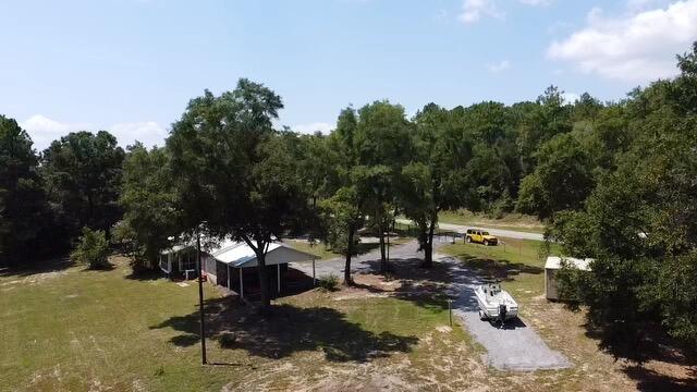 1086 County Highway 183 North DeFuniak Springs, FL 32433 - Photo 37 of 39 a view of a bench in the backyard of a house