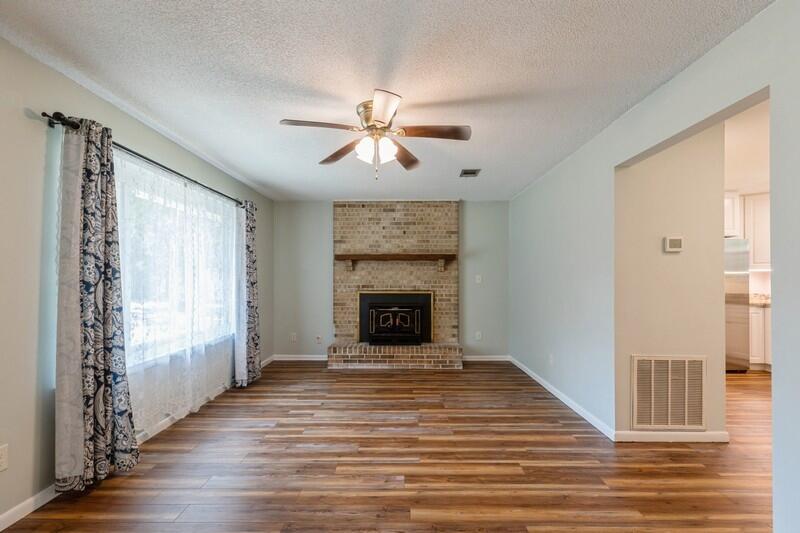 1086 County Highway 183 North DeFuniak Springs, FL 32433 - Photo 5 of 39 a view of a livingroom with a fireplace window and wooden floor