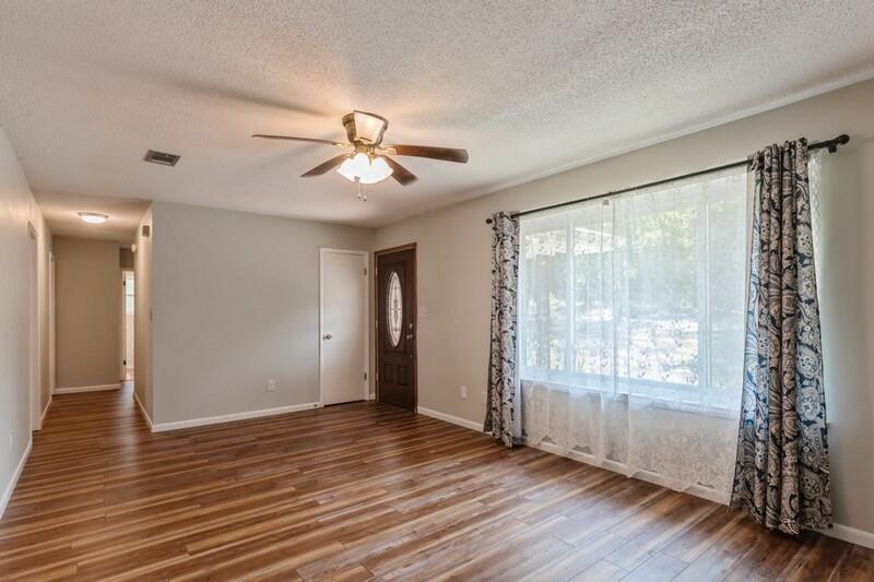 1086 County Highway 183 North DeFuniak Springs, FL 32433 - Photo 7 of 39 a view of an empty room with window and wooden floor