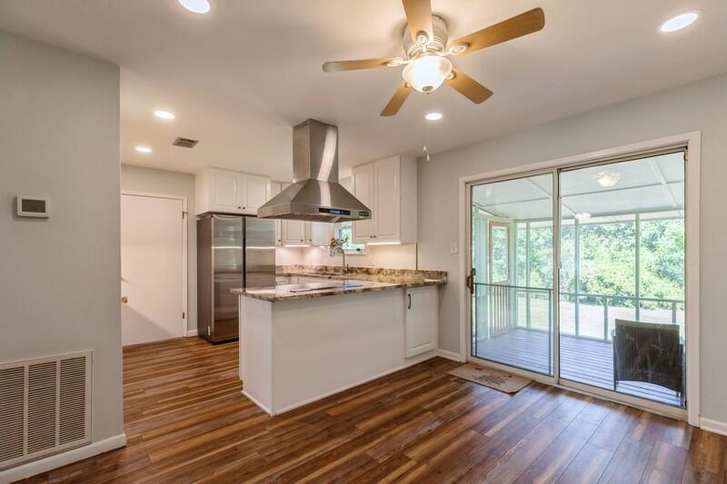 1086 County Highway 183 North DeFuniak Springs, FL 32433 - Photo 8 of 39 a kitchen with stainless steel appliances granite countertop a stove and a wooden floors