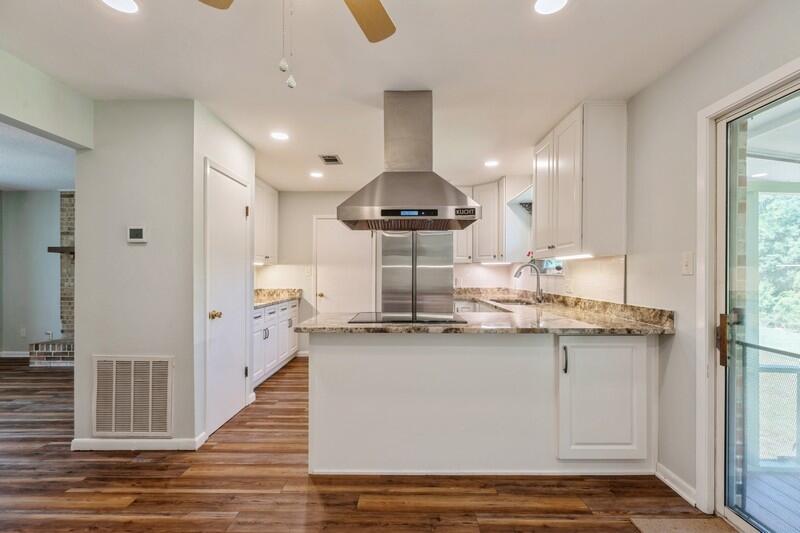 1086 County Highway 183 North DeFuniak Springs, FL 32433 - Photo 9 of 39 a kitchen with stainless steel appliances granite countertop a sink and cabinets