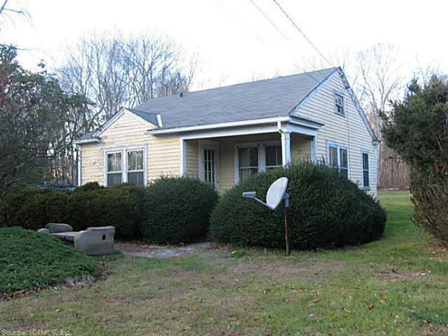 a view of a house with a backyard and a garden