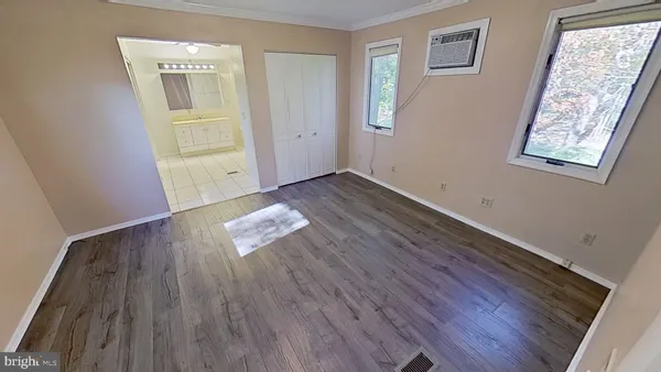 wooden floor in an empty room with a window