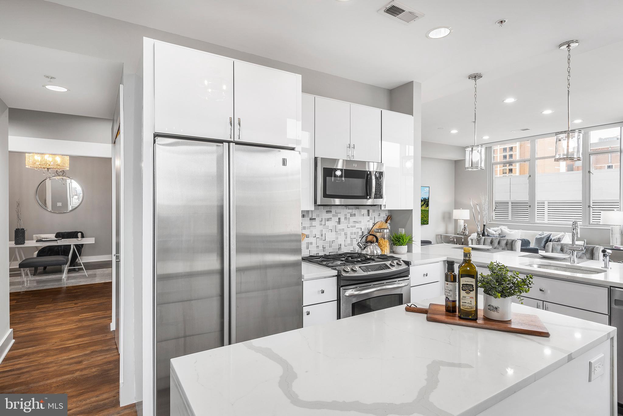 1101 Locust Street, Unit 8B Philadelphia, PA 19107 - Photo 12 of 36 a kitchen with stainless steel appliances a refrigerator sink and stove