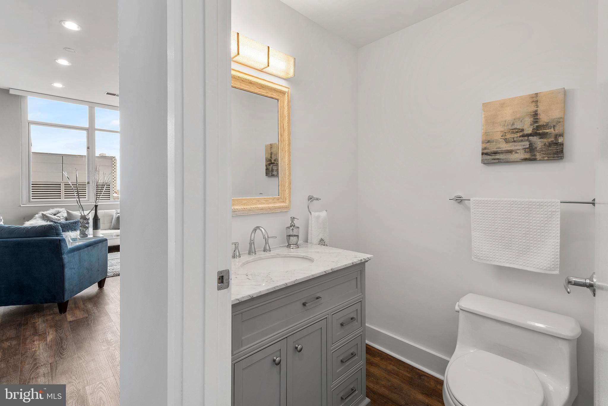 1101 Locust Street, Unit 8B Philadelphia, PA 19107 - Photo 15 of 36 a bathroom with a toilet a sink and mirror
