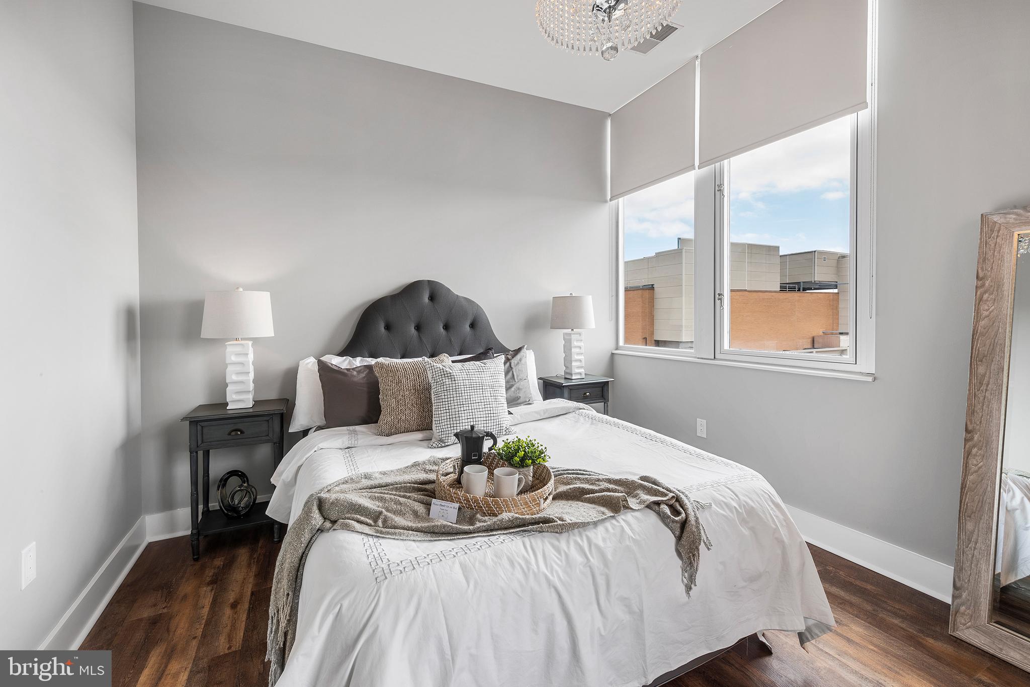 1101 Locust Street, Unit 8B Philadelphia, PA 19107 - Photo 26 of 36 a bed sitting in a bedroom next to a window