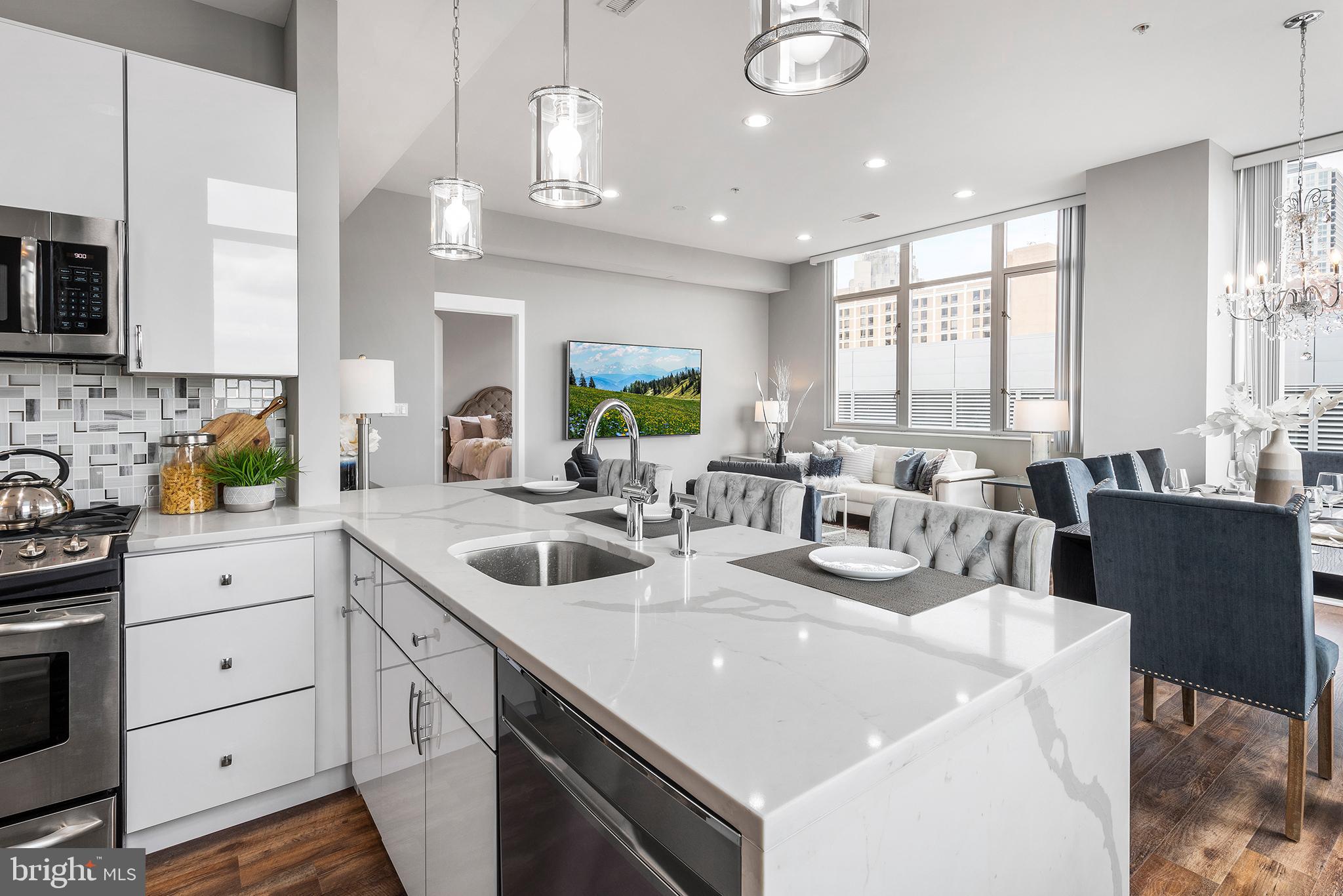 1101 Locust Street, Unit 8B Philadelphia, PA 19107 - Photo 10 of 36 a view of a kitchen area with windows and furniture