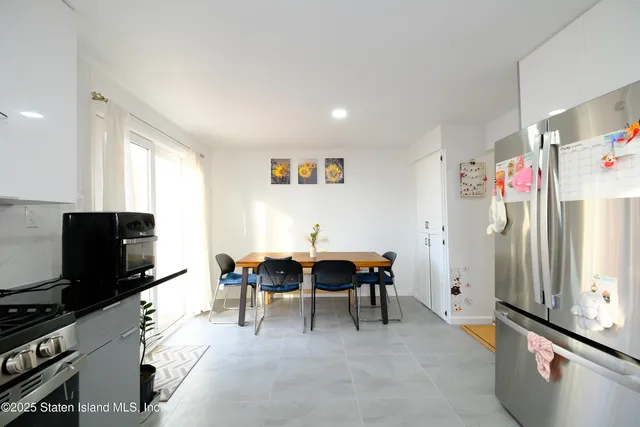 a kitchen with granite countertop a stove and a refrigerator