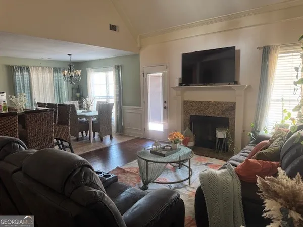 a living room with furniture a fireplace and a flat screen tv