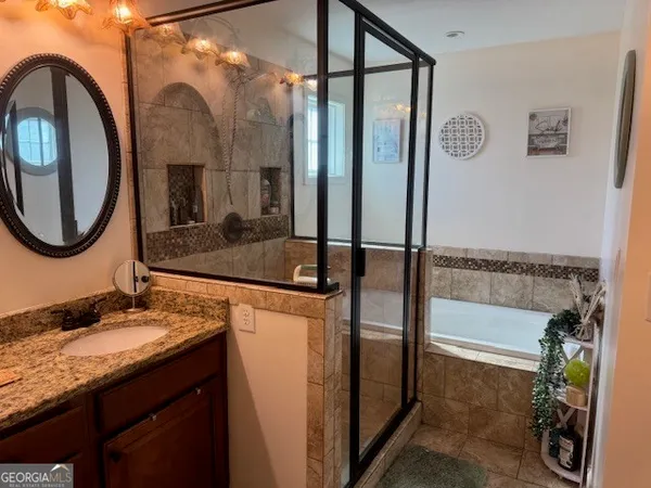 a bathroom with a granite countertop sink and a mirror