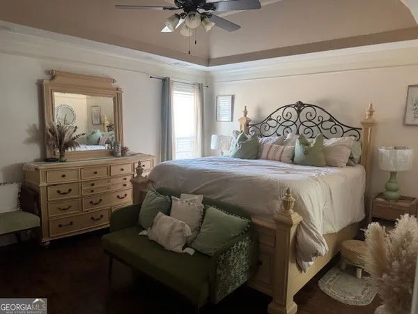 a bedroom with a bed and a dresser