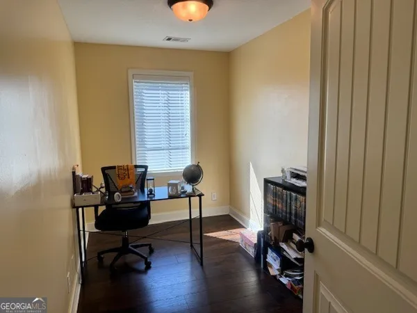 a livingroom with workspace and a window