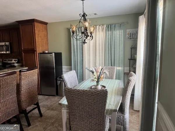 a view of a dining room with furniture window and outside view